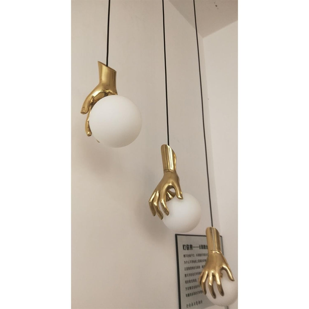 Avnorira Hand Holding Globe Brass Glass Pendant Light